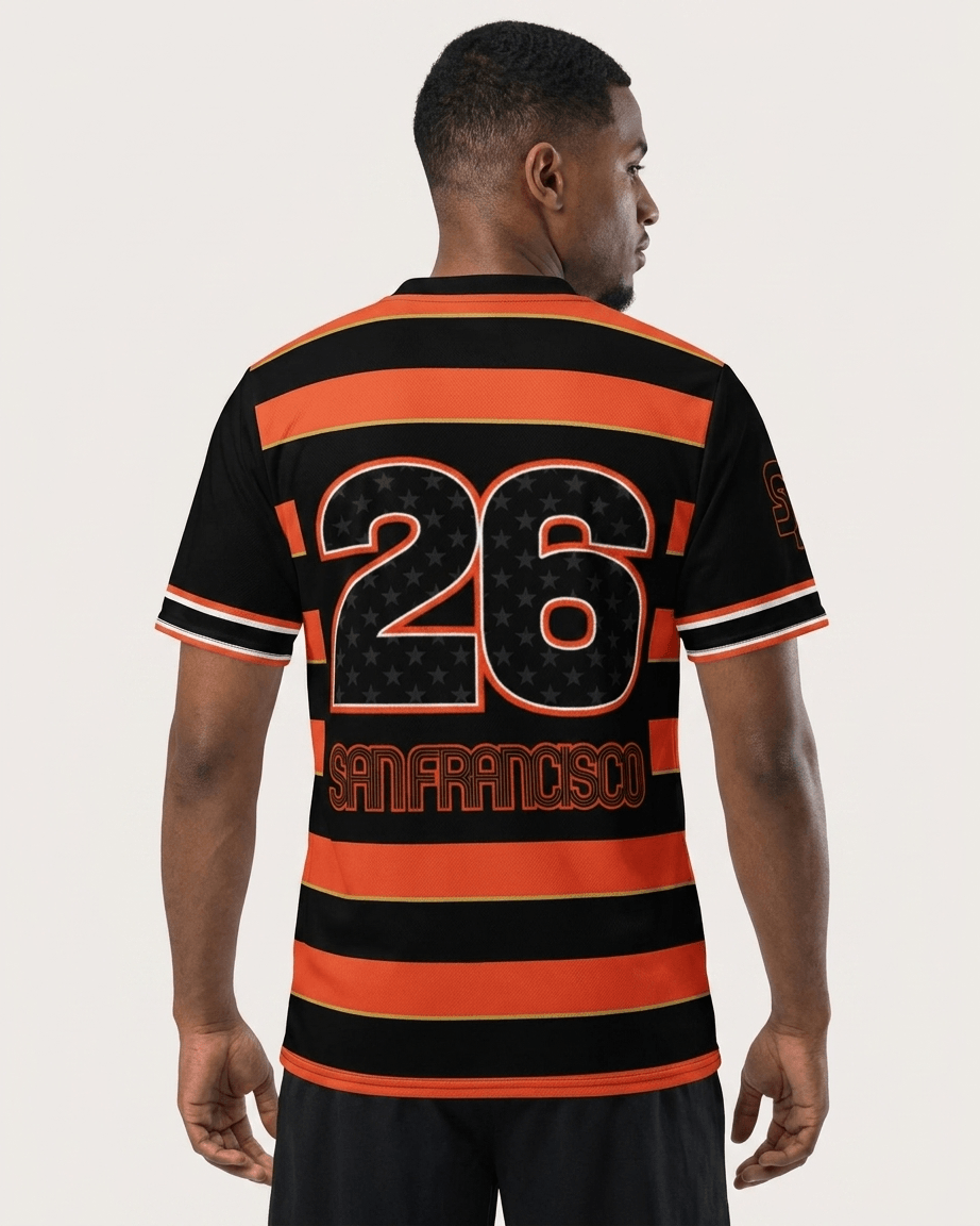 A man viewed from the back wearing a black and orange striped soccer jersey with the number 26 and 'SAN FRANCISCO' printed on the back, set against a light gray studio background.