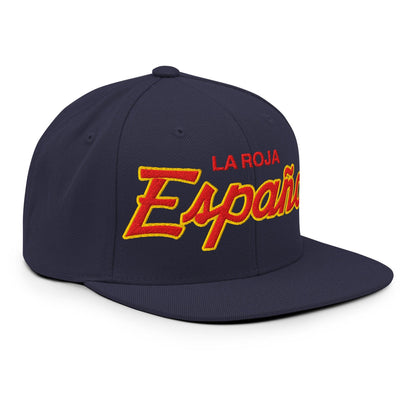 A navy blue flat-brim baseball cap with 'LA ROJA Espana' embroidered on the front in red and yellow, shown on a plain white background.
