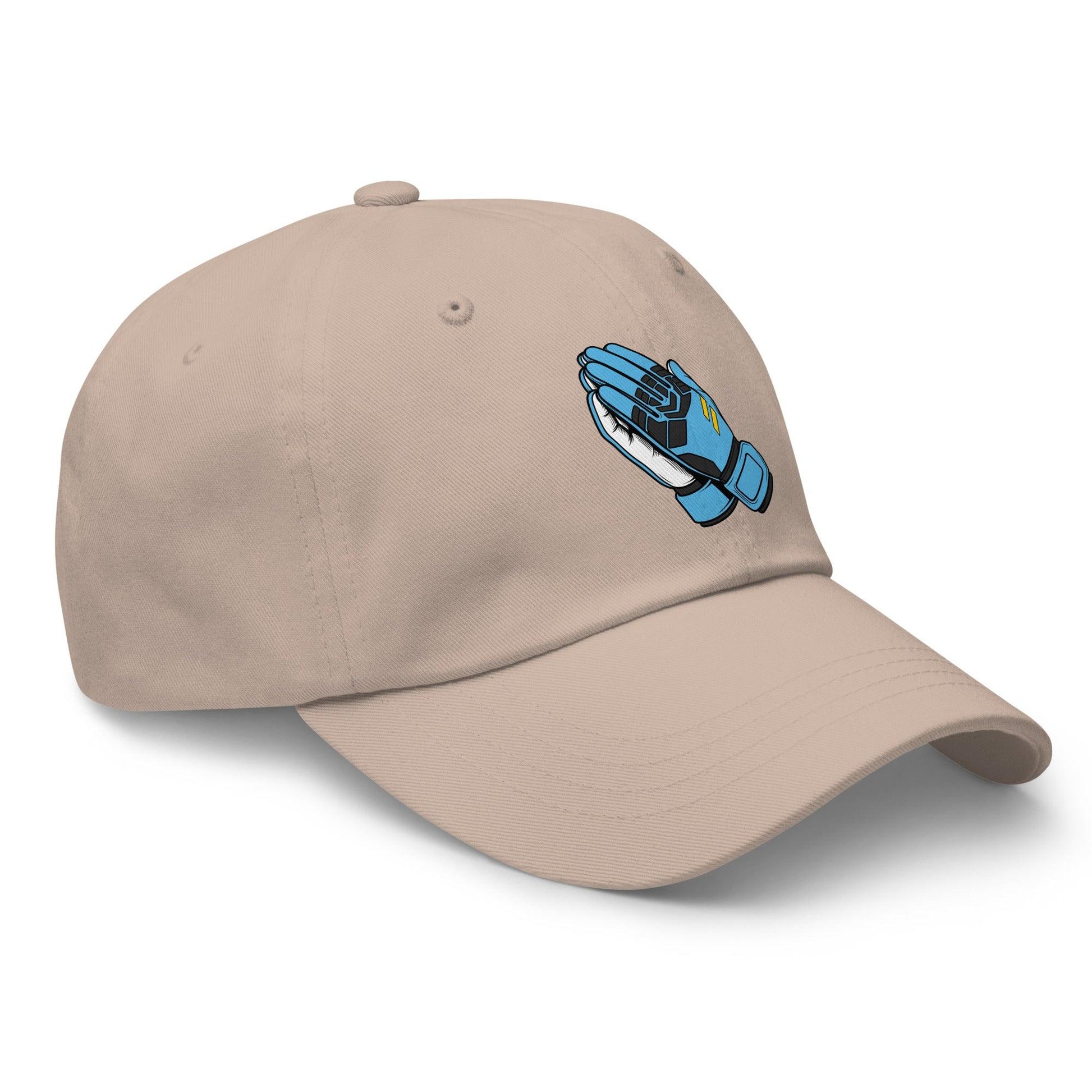 Beige soccer hat with a blue and black goalie gloves in prayer design on a white background